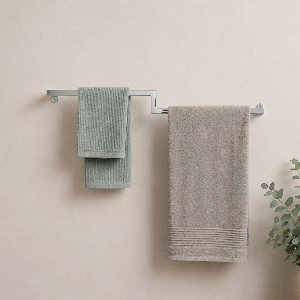 Satin nickel wall mounted offset double towel bar holding mint and gray towels on a bathroom wall.