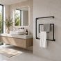 Black wall mounted square swivel towel rack holding gray and white towels beside a modern bathroom vanity.