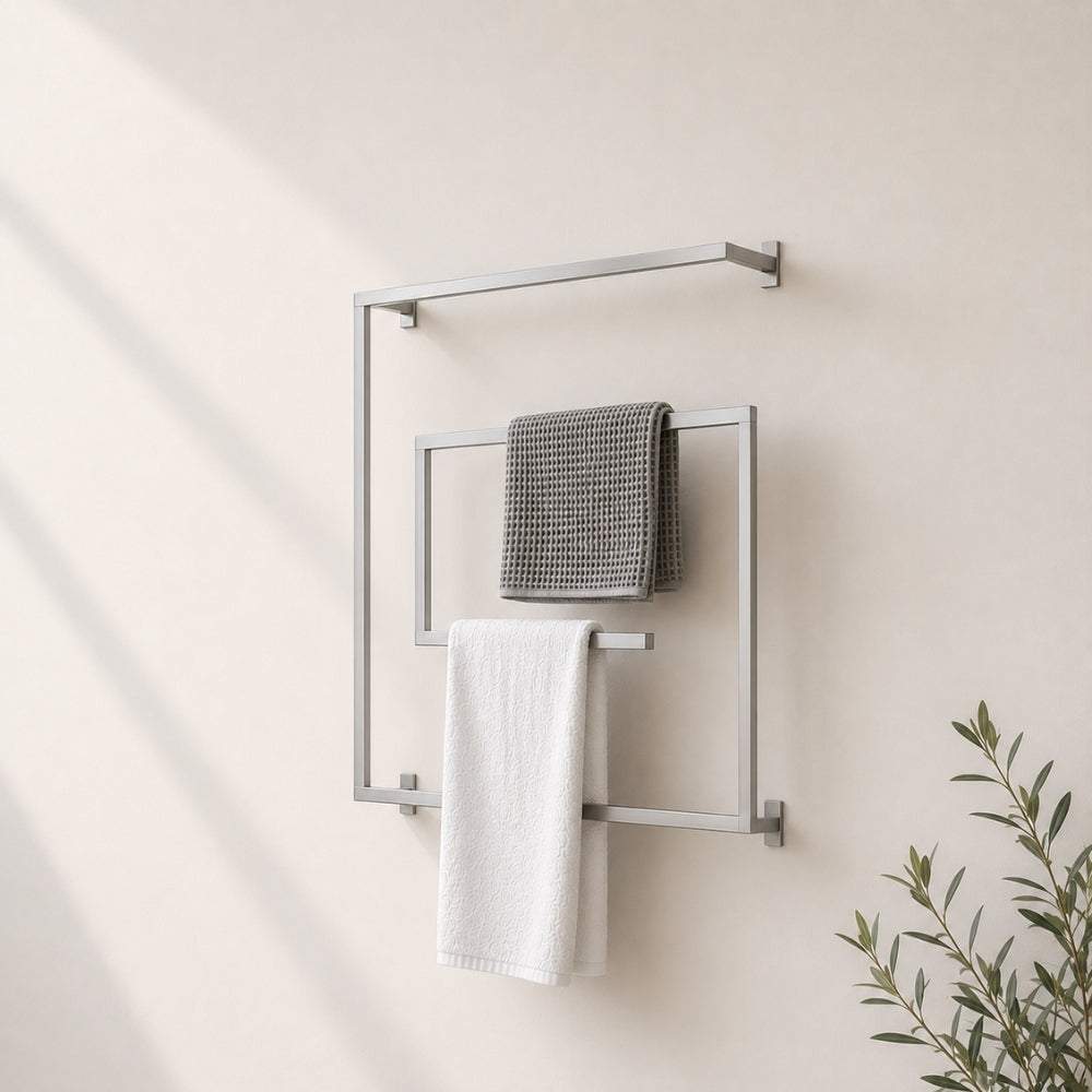 Satin nickel wall mounted square swivel towel rack holding gray and white towels on a bathroom wall.