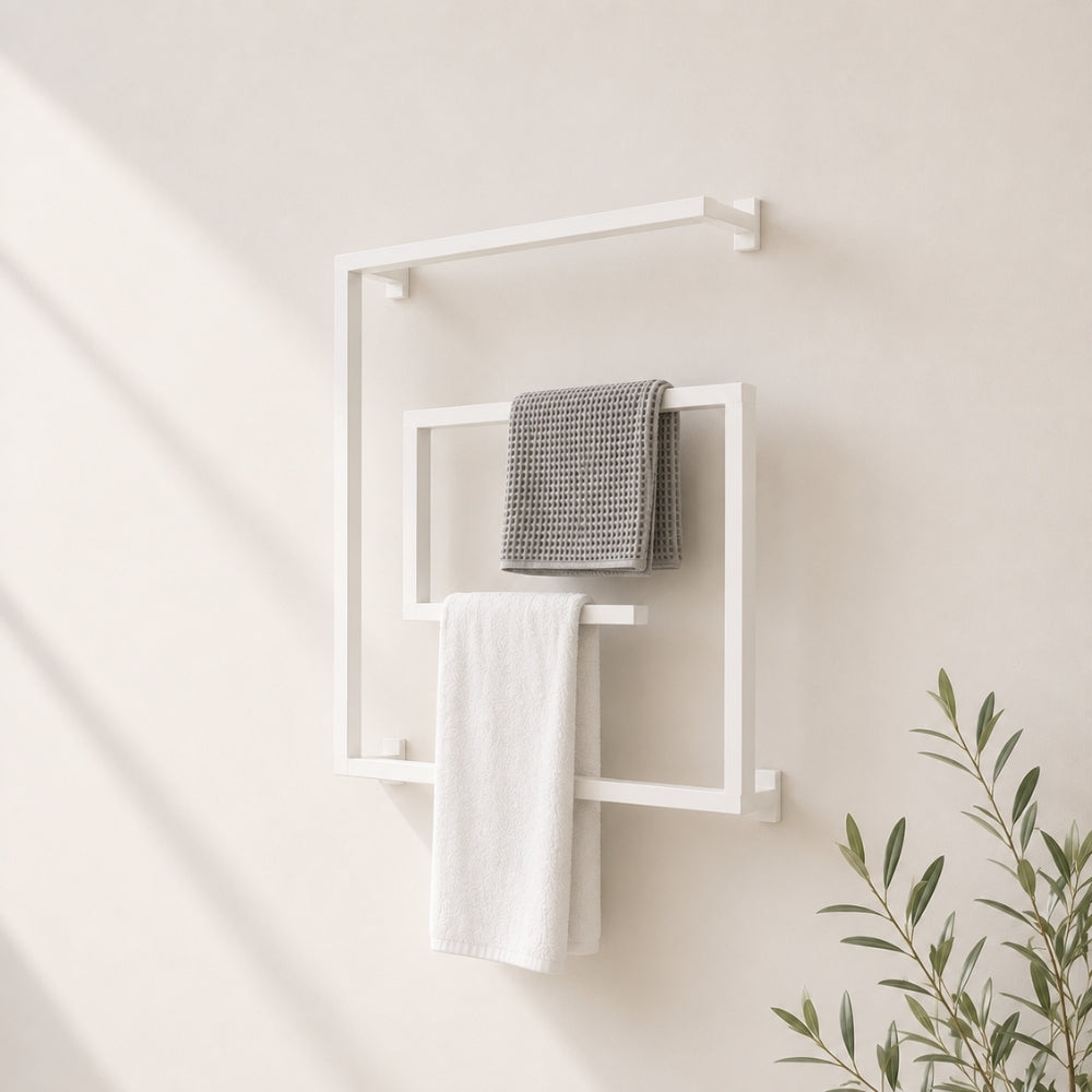 White wall mounted square swivel towel rack holding gray and white towels on a bathroom wall.