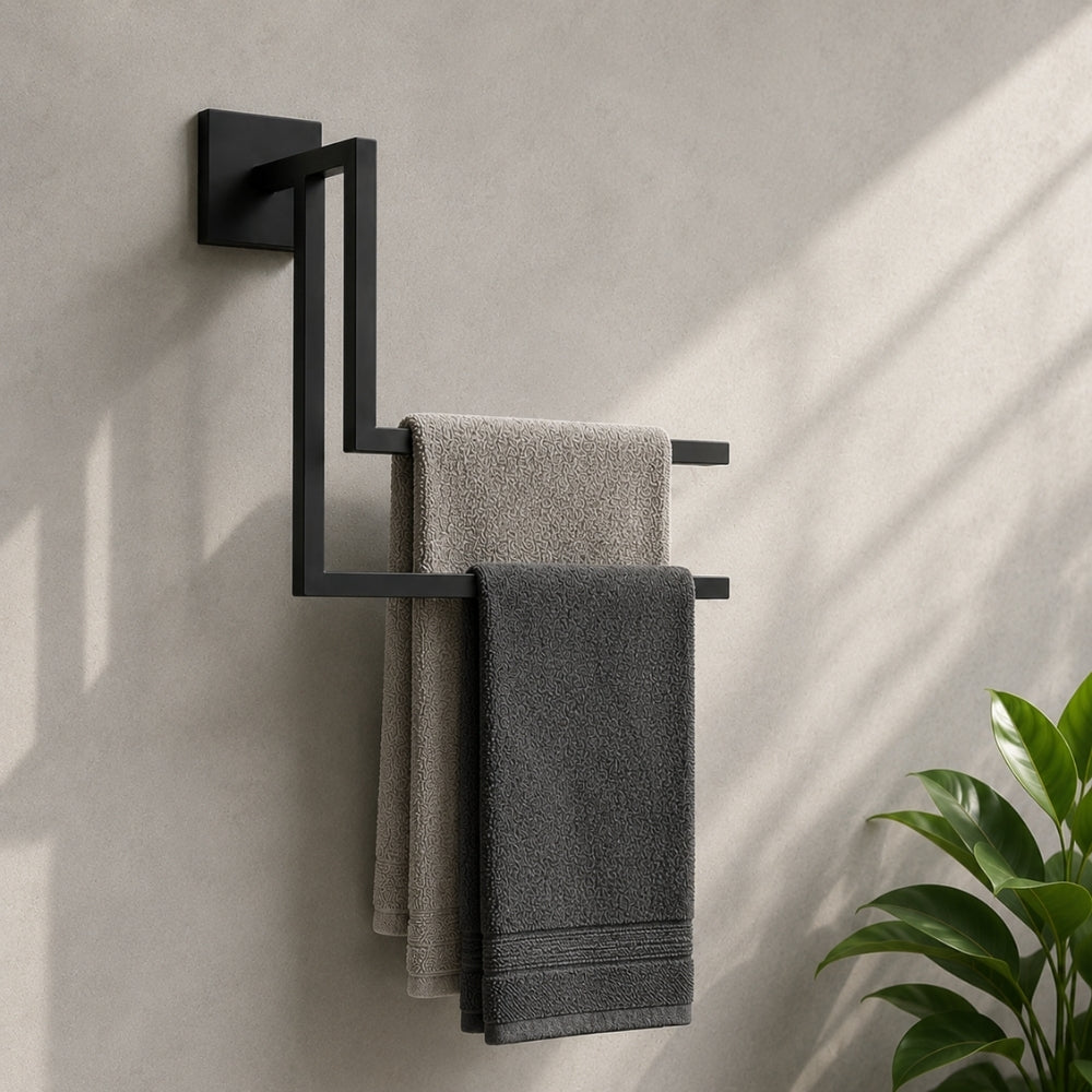 Black wall mounted staggered towel rack holding gray towels on a bathroom wall.