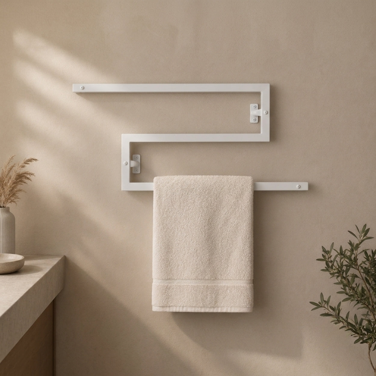 White wall mounted zigzag swivel towel rack holding a towel.
