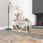 A stylish white metal log holder with a wooden bench placed next to a modern fireplace. Logs are neatly stacked under the bench, and decorative accents complement the soft, neutral-toned room