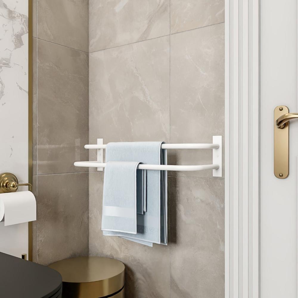 A clean and minimalistic bathroom setting featuring a white double-bar towel holder mounted on the wall, holding neatly folded blue towels. The neutral tones of the tiles and the golden door handle add an elegant touch to the overall design.