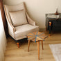 Blue Snowflake Epoxy Side Table in a cozy living room setting, placed near a beige armchair and black side table.