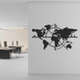 Black world map wall decoration in an office setting