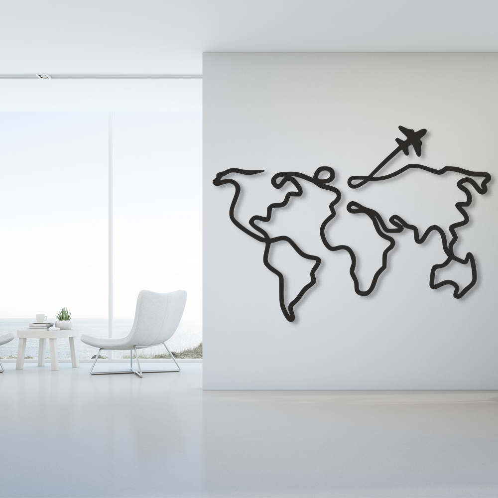 Black world map wall art with an airplane on a white wall in a modern room.